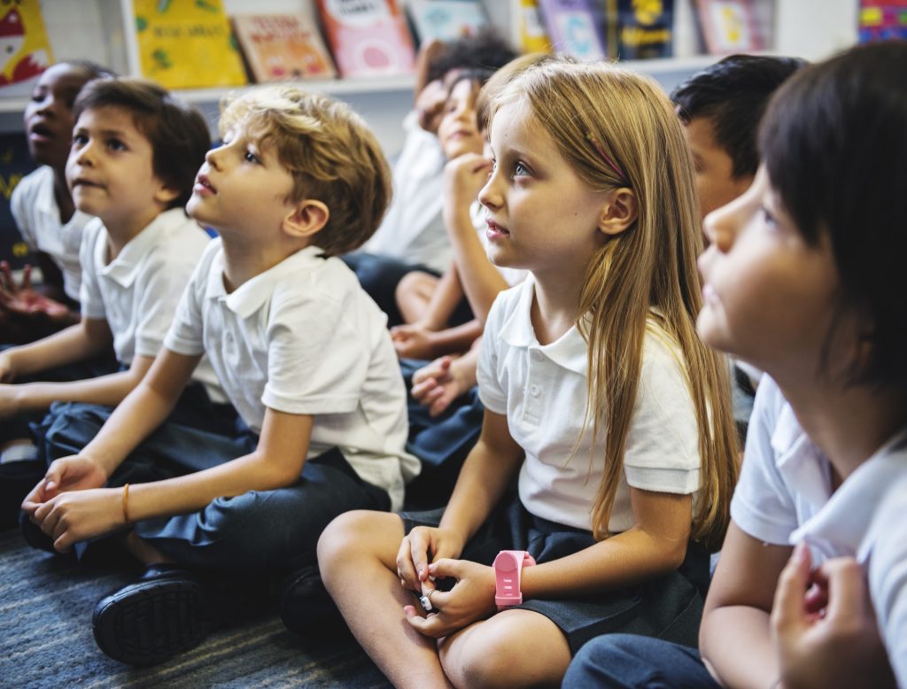 Kindergarten students sitting on the floor