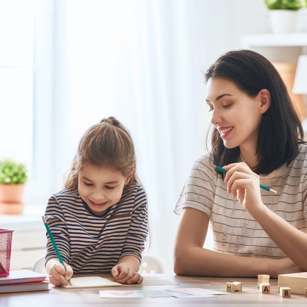 woman teaches child the alphabet